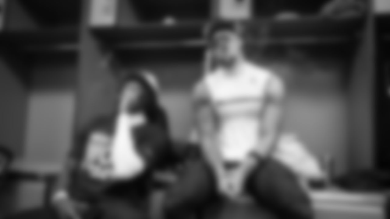 Receivers Jaxon Smith-Njigba and Rashid Shaheed celebrate with victory cigars.