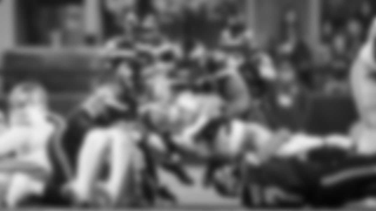 Seattle's "Dark Side" defense gang tackles 49ers running back Christian McCaffrey early in the game.