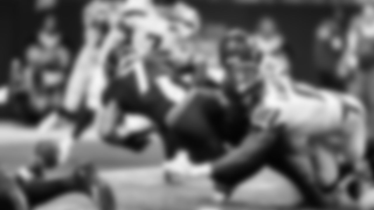 Seattle's DeMarcus Lawrence punches the ball away from Atlanta's Bijan Robinson for a fumble that would be recovered by the Seahawks' Devon Witherspoon.