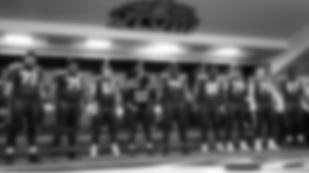 The Seahawks join hands in prayer before taking the field against the Rams in the NFC Championship game.