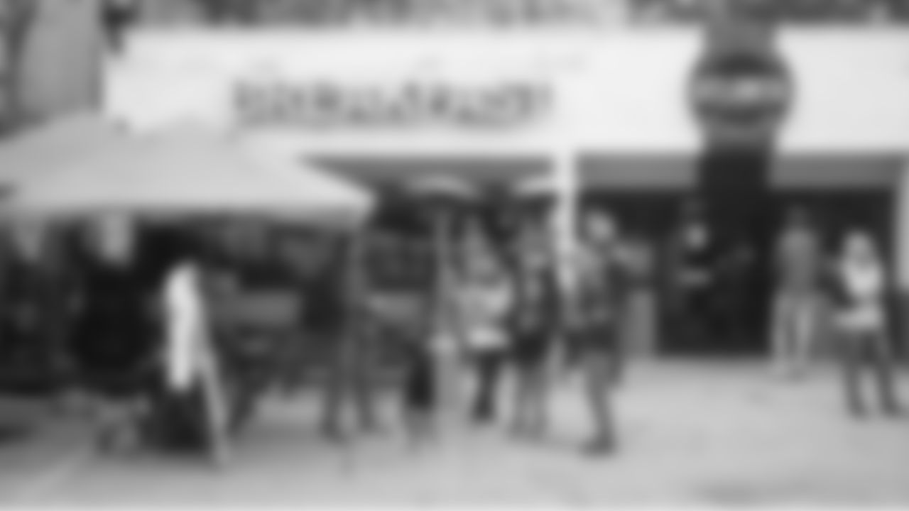 12s watch from a local brunch spot as team buses carrying Seahawks players, coaches and staff passes by on the way to the stadium.