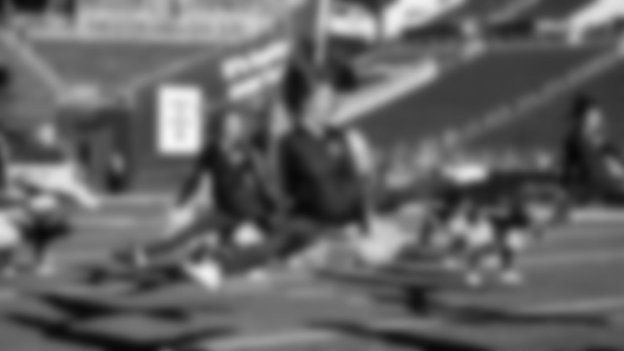 Macy rehearsing with her teammates before kickoff.