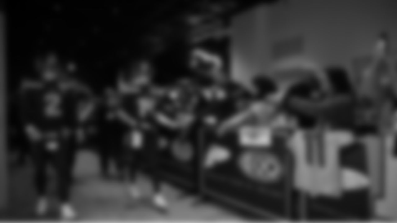 Seahawks quarterback Drew Lock (2) and quarterback Sam Darnold (14) walks through the Emerald Queen Casino tunnel club at Lumen Field for the Week 15 matchup vs. the Colts.