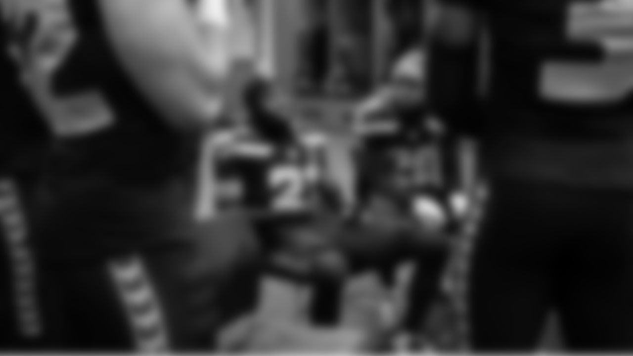 Cornerback Devon Witherspoon talks to teammates in the locker room during halftime.