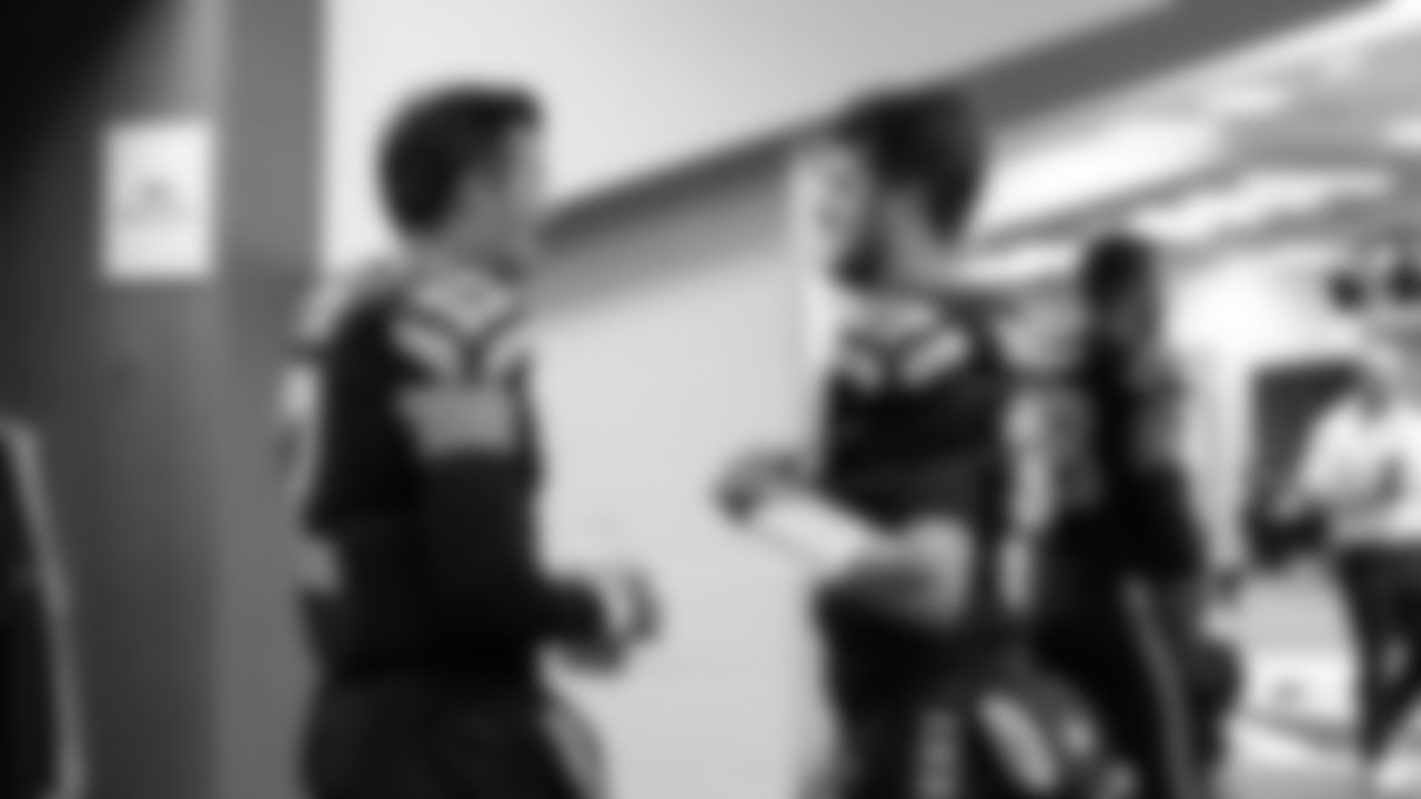 Seahawks quarterbacks Drew Lock and Sam Darnold talk in the locker room prior to the game.