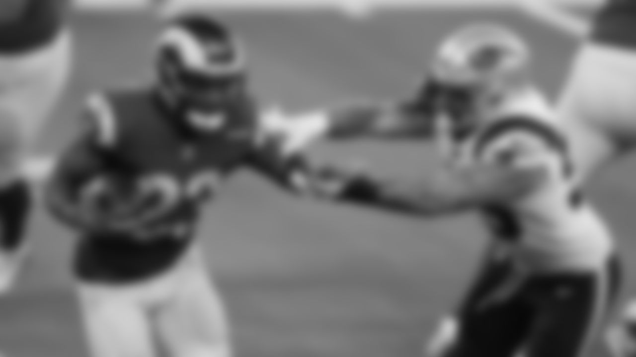 Los Angeles Rams running back Cam Akers (23) carries the ball in front of New England Patriots defensive end John Simon (55) during an NFL football game, Thursday, Dec. 10, 2020 in Inglewood, Calif. (Ben Liebenberg via AP)