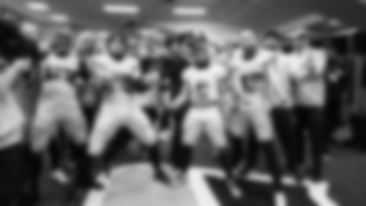 Seahawks players pose in the locker room after the dramatic win over the Rams.