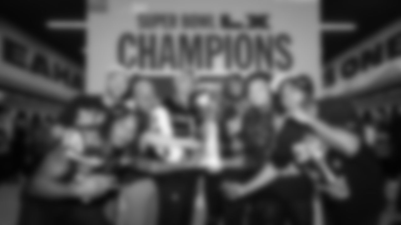 Seahawks running backs gather with Super Bowl MVP Kenneth Walker III and the Lombardi Trophy. From left are Velus Jones Jr, coaches Justin Outten and Michael Byrne, Zack Charbonnet, Walker, Jacardia Wright, George Holani and Kenny McIntosh.