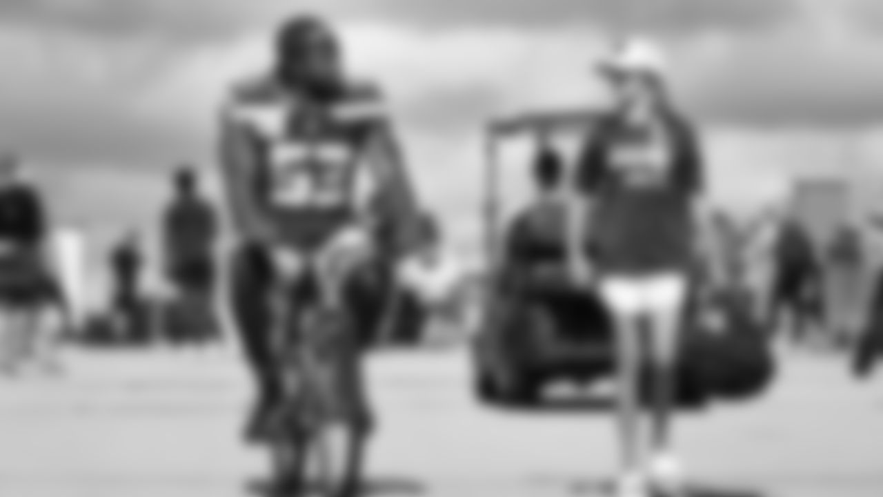 Seahawks linebacker Boye Mafe (53) rides a bike on their way to practice on August 21, 2025 in Green Bay, Wisconsin.