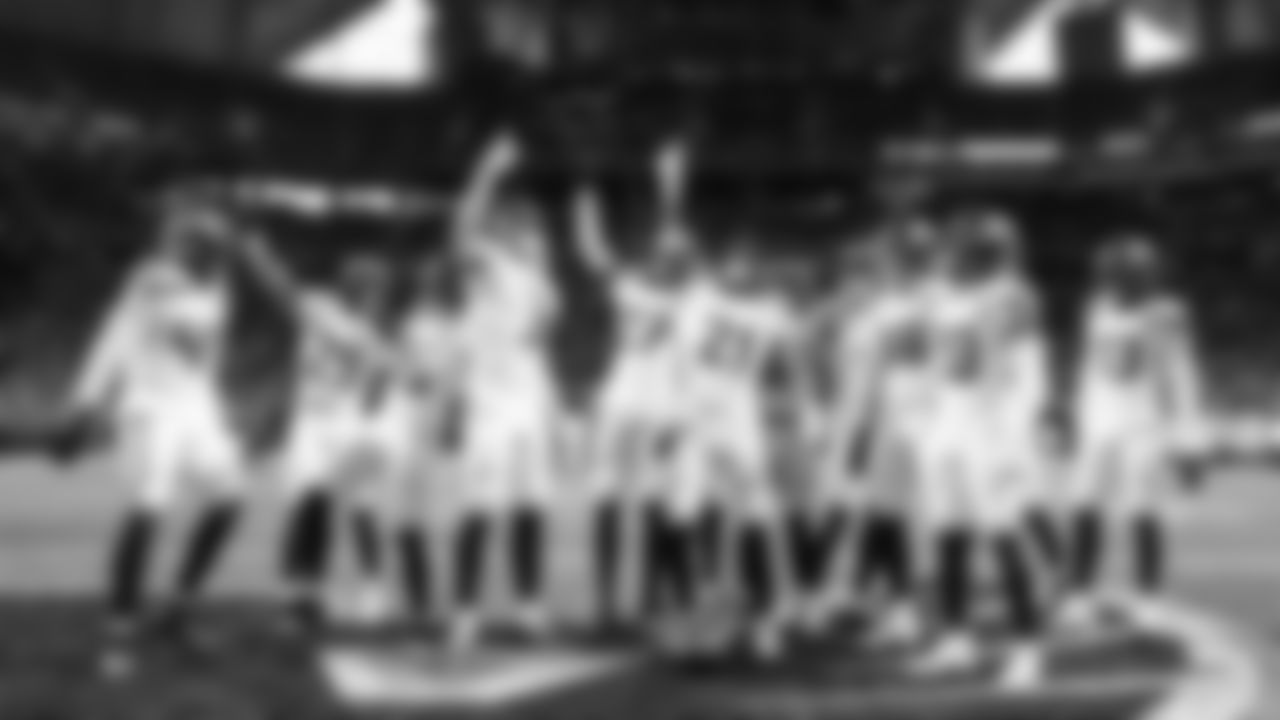 Members of the Seahawks defense celebrate after Devon Witherspoon intercepted a pass in the fourth quarter.