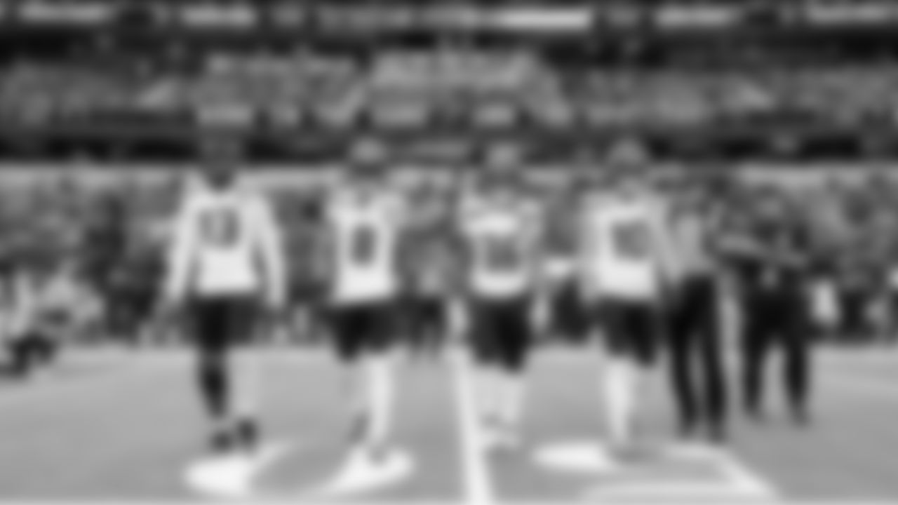 Seahawks game captains Ernest Jones IV, Coby Bryant, George Holani and Cooper Kupp head to midfield for the opening coin toss.