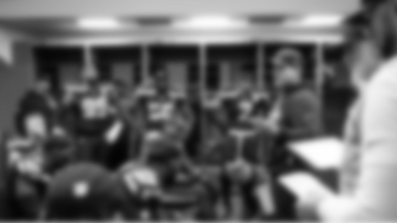 Seahawks head coach Mike Macdonald talks to members of the defense at halftime.