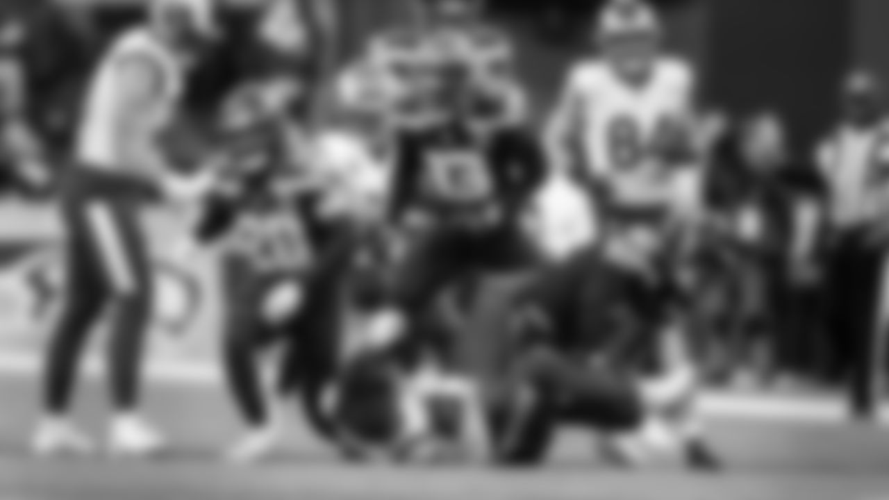 Seattle's Ernest Jones IV, Julian Love and Drake Thomas drop Rams receiver Puka Nacua, who lost his helmet on the play.