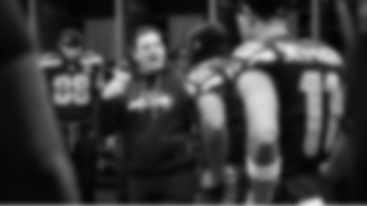 At halftime, Seahawks head coach Mike Macdonald gives final instructions to the team before they take the field for the second half.