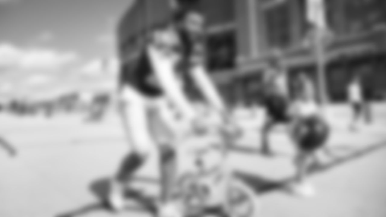 Seahawks safety Julian Love (20) rides a bike on their way to practice on August 21, 2025 in Green Bay, Wisconsin.