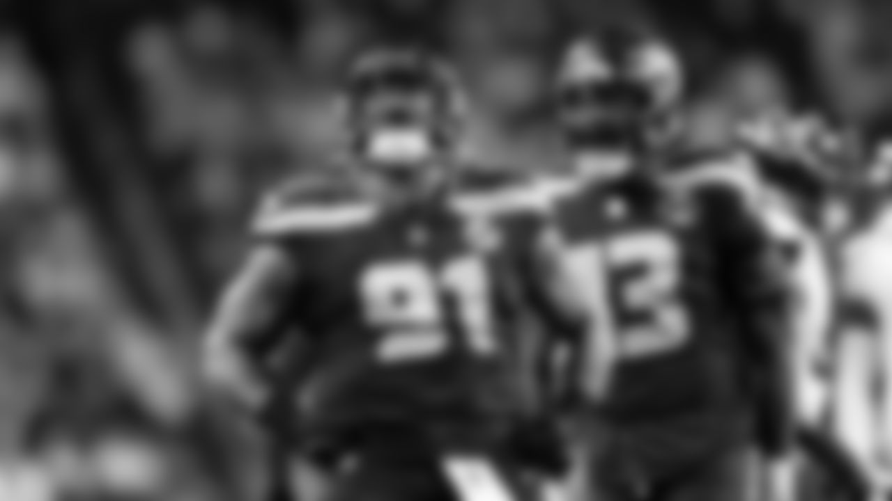 Seahawks defensive lineman Byron Murphy II lets out a yell after making a play with Ernest Jones IV.