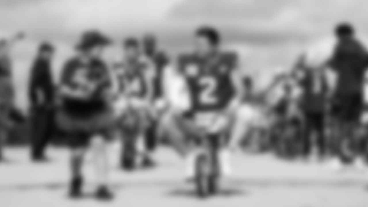 Seahawks quarterback Drew Lock rides a kid's bike from the visitors locker room at Lambeau Field to a nearby practice field prior to joint practices between the Seahawks and Packers.