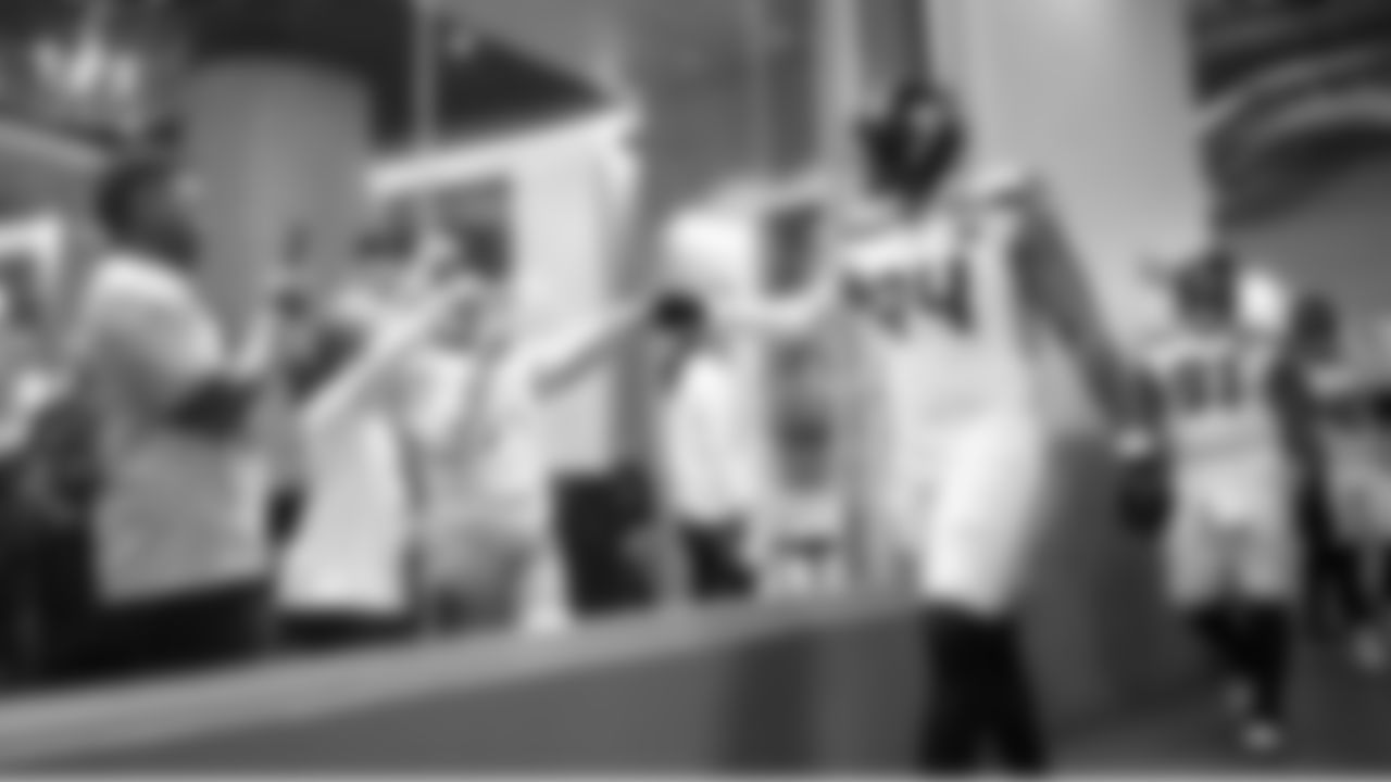 Seahawks defensive end Mike Morris greets 12s as he and teammates head to the field for kickoff.