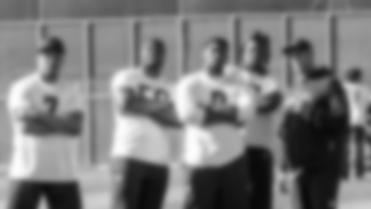 Members of the Seahawks linebacking corps Uchenna Nwosu, Derick Hall, DeMarcus Lawrence and Boye Mafe pose with defensive coordinator Aden Durde.