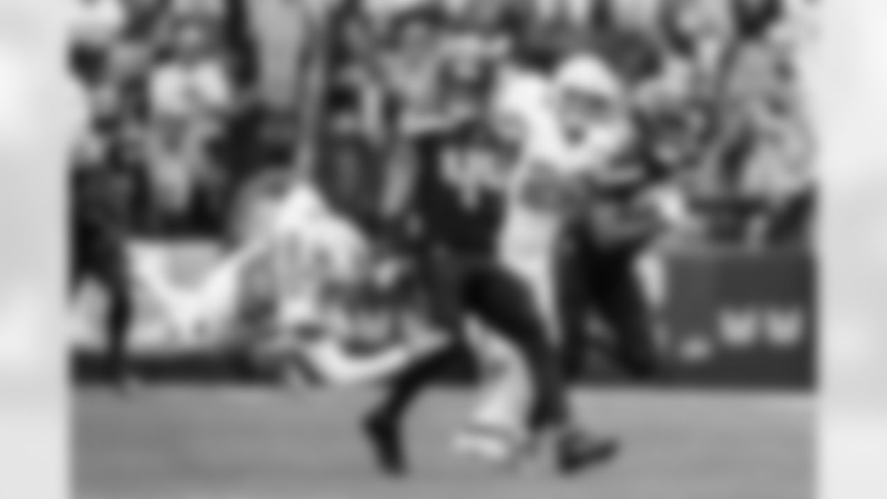 Seahawks special teamer Chazz Surratt sends Saints punter Kai Kroeger flying as he blocks on Tory Horton's 95-yard punt return for a touchdown.