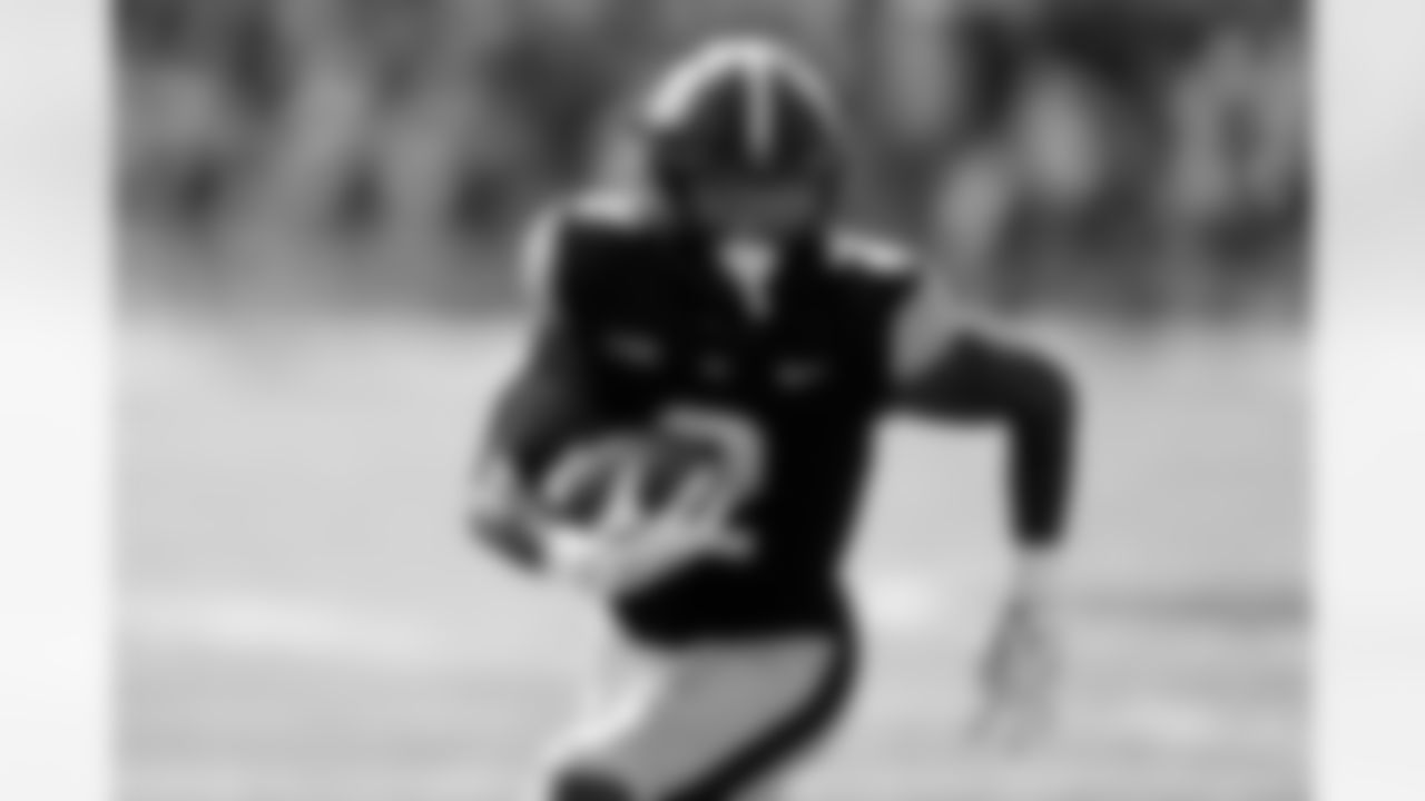 Iowa running back Kaleb Johnson runs up field after catching a pass during the first half of an NCAA college football game against Washington, Saturday, Oct. 12, 2024, in Iowa City, Iowa. (AP Photo/Charlie Neibergall)