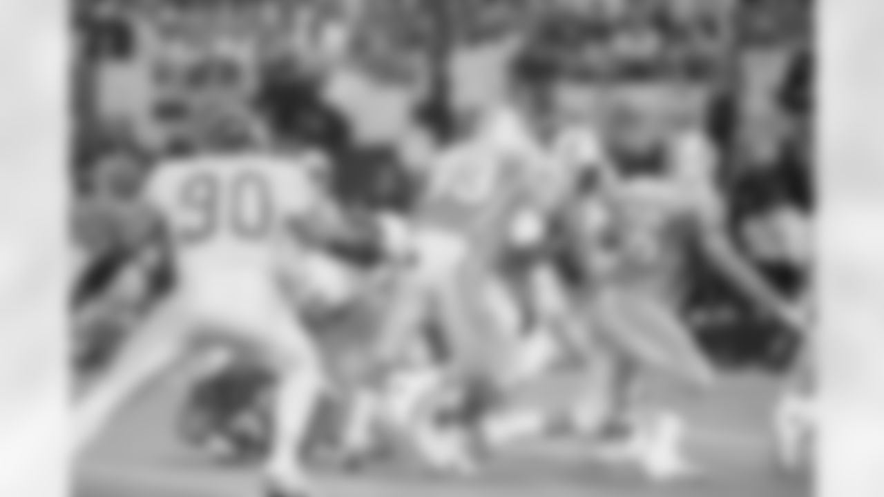 Houston Oilers' running back Gary Brown (33) with protection from teammates Doug Dawson (66) and Mike Munchak (63) runs for a two-yard touch down against the Kansas City Chiefs on Sunday, Jan. 16, 1994 at the Houston Astrodome. (AP Photo/Tim Johnson)