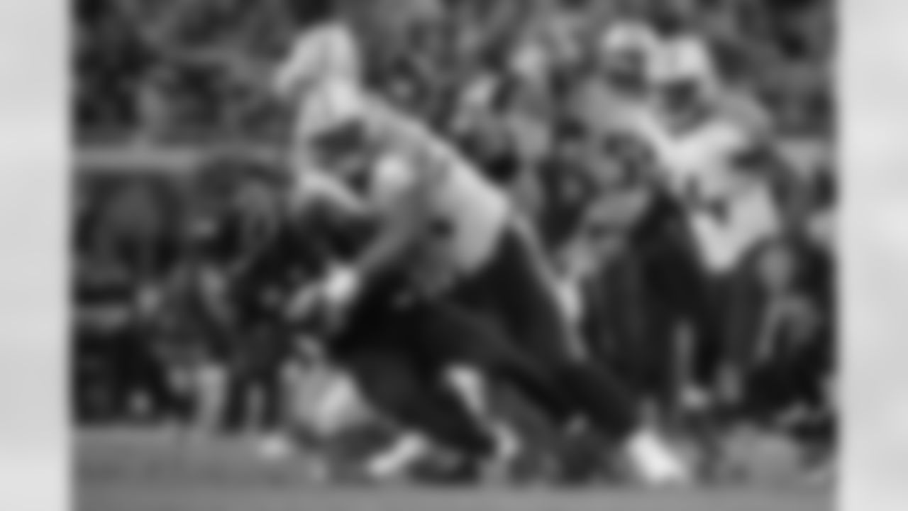 Jacksonville Jaguars running back Storm Johnson (34) is tackled by Tennessee Titans nose tackle Sammie Lee Hill (94) after rushing for yardage during the first half of an NFL football game in Jacksonville, Fla., Thursday, Dec. 18, 2014.(AP Photo/Phelan M. Ebenhack)