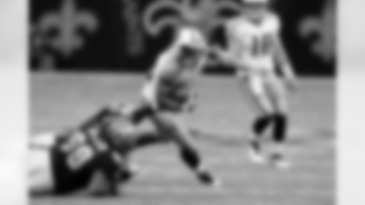 Tennessee Titans running back Kestahn Moore tries to elude a tackle by a fallen New Orleans Saints defensive end Junior Galette (93) during the second half of an NFL preseason football game at the Louisiana Superdome in New Orleans, Thursday, Sept. 1, 2011. (AP Photo/Bill Haber)