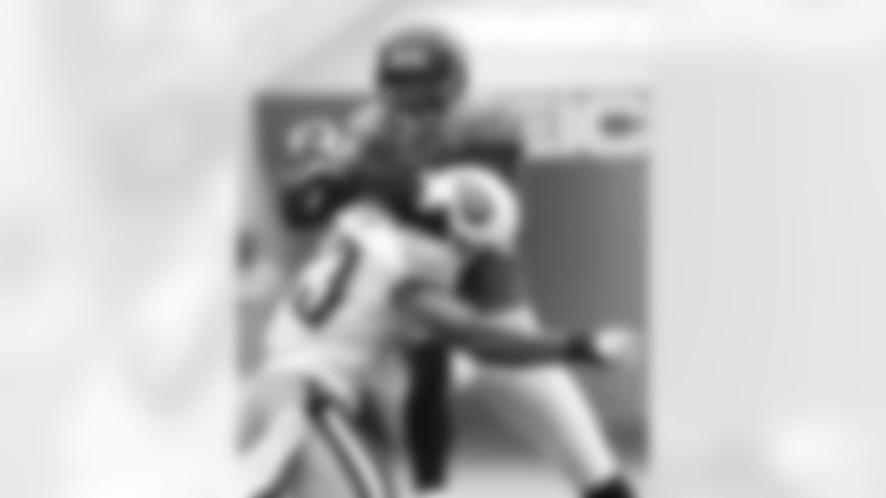 Jacksonville Jaguars wide receiver Mike Walker makes a catch over Tennessee Titans safety Michael Griffin during the second quarter of an NFL football game, Sunday, Oct. 4, 2009, in Jacksonville, Fla. (AP Photo/Phil Coale)