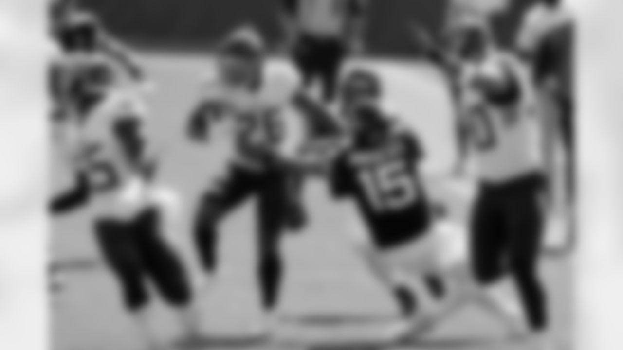 Tennessee Titans cornerback Kristian Fulton (26) runs back an interception as Jacksonville Jaguars quarterback Gardner Minshew (15) tries to tackle him in the first half of an NFL football game Sunday, Sept. 20, 2020, in Nashville, Tenn. (AP Photo/Wade Payne)