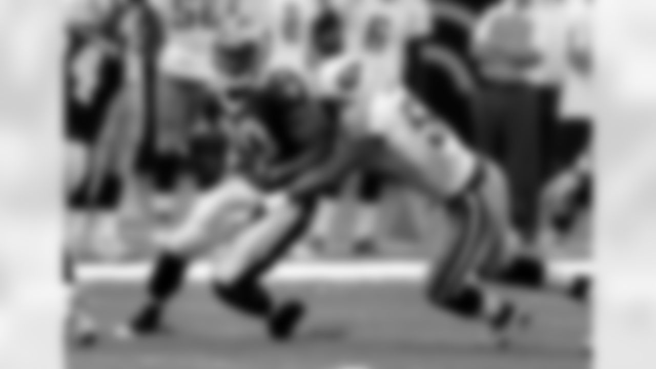 New Orleans Saints running back Joique Bell (20) is wrapped up by Tennessee Titans linebacker Gerald McRath (51) during the first quarter of an NFL preseason football game at the Louisiana Superdome in New Orleans, Thursday, Sept. 1, 2011. (AP Photo/Bill Haber)