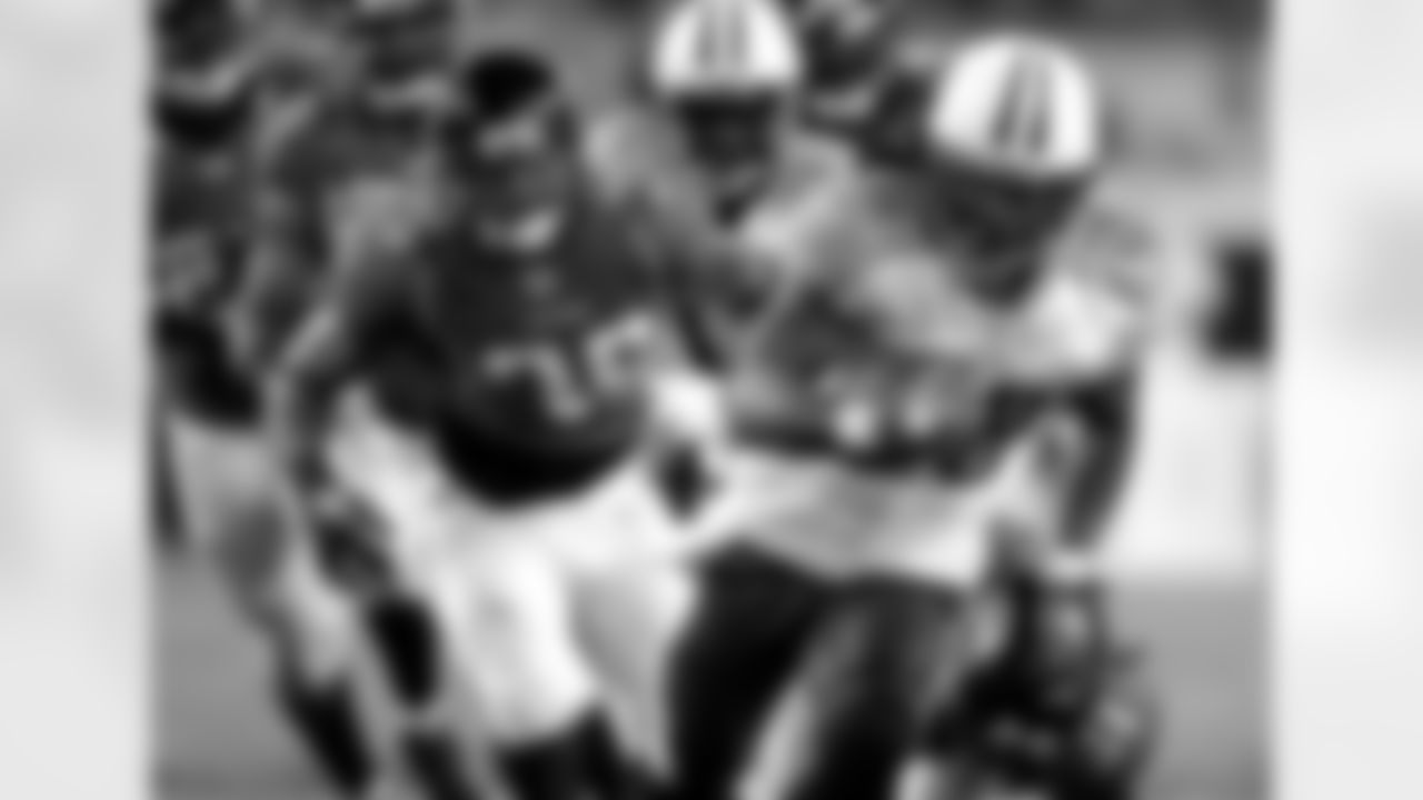 FILE - This Oct. 18, 2010 file photo shows Tennessee Titans running back Chris Johnson (28) running for a 35-yard touchdown past Jacksonville Jaguars safety Courtney Greene (36) during the second half of an NFL football game,  in Jacksonville, Fla. The Titans say they will make the three-time Pro Bowler the highest paid running back in the NFL.  (AP Photo/John Raoux, File)