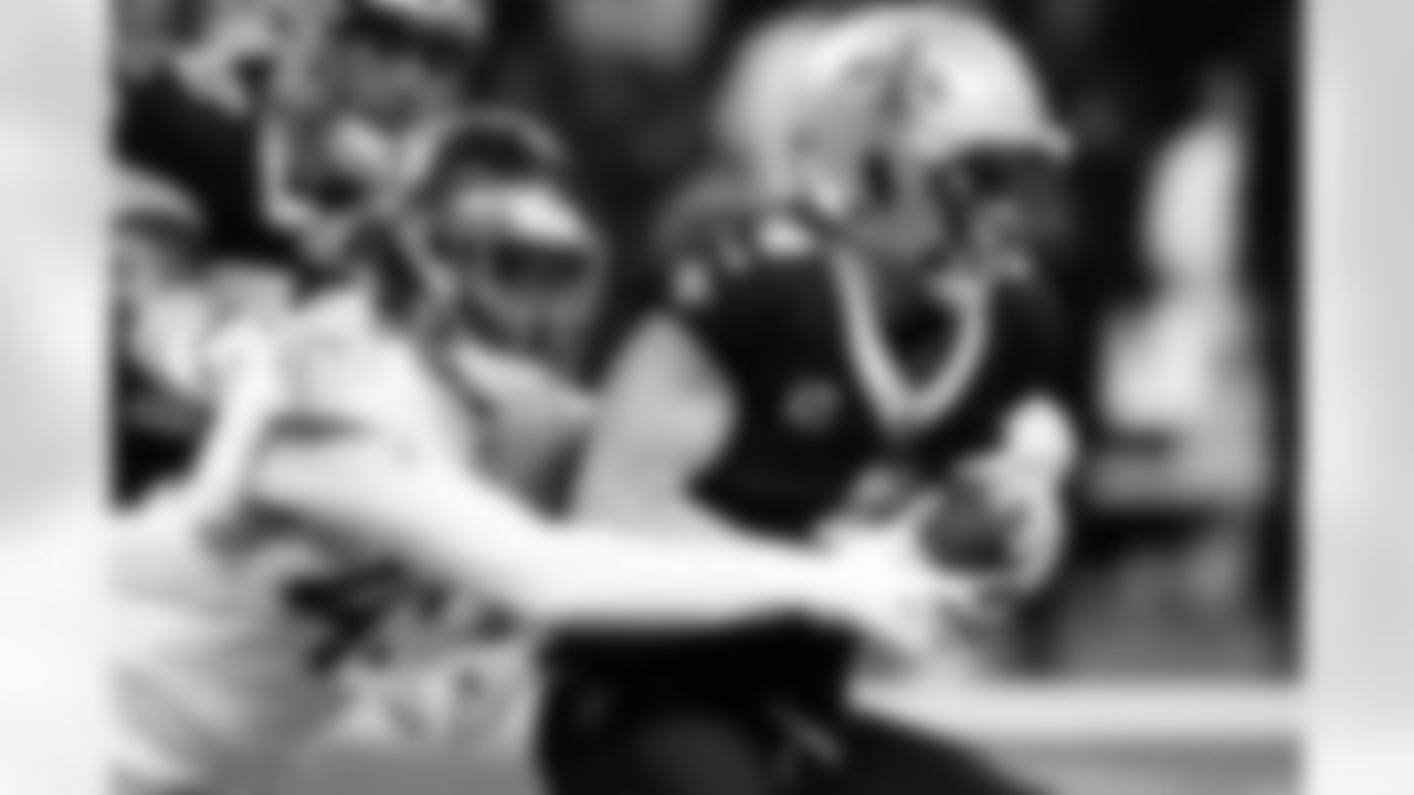 Tennessee Titans linebacker Arden Key, left, sacks New Orleans Saints quarterback Derek Carr in the first half of an NFL football game in New Orleans, Sunday, Sept. 10, 2023. (AP Photo/Butch Dill)