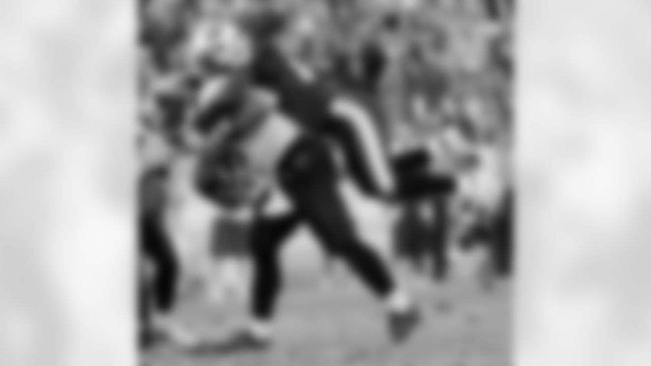 Tennessee Titans safety Lamont Thompson (28) hangs on the back of Jacksonville Jaguars quarterback David Garrard (9) in the fourth quarter of an NFL football game in Nashville, Tenn., Sunday, Dec. 17, 2006. The Titans beat the Jaguars, 24-17. (AP Photo/John Russell)