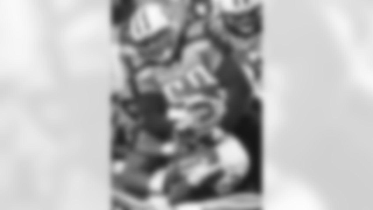 Tennessee Titans linebacker Ken Amato (58) hangs on to Kansas City Chiefs running back Derrick Blaylock (23) and Blaylock hangs on to the ball as he scores a touchdown on a 1-yard run in the third quarter on Monday, Dec. 13, 2004 in Nashville, Tenn. (AP Photo/John Russell)