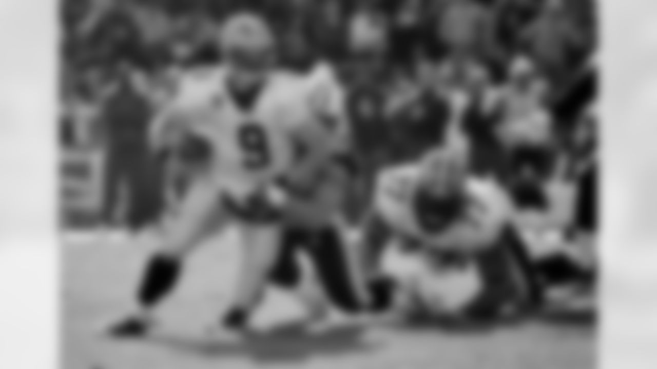 New Orleans Saints quarterback Drew Brees (9) is sacked by Tennessee Titans defensive tackle Karl Klug for a 7-yard loss in the second quarter of an NFL football game on Sunday, Dec. 11, 2011, in Nashville, Tenn. At right is New Orleans Saints offensive guard Carl Nicks (77).  (AP Photo/Frederick Breedon)