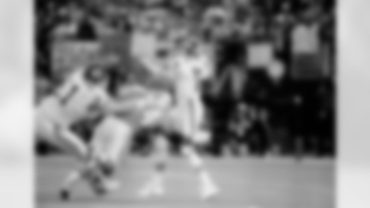 Kansas City chief's Tim Grunhard (61) tries to help Chief's quarterback Joe Montana (19) as he is pressured by Houston Oilers' Glenn Montgomery (94) in the first quarter Sunday Jan. 16, 1994 in Houston. (AP Photo/Tim Johnson)