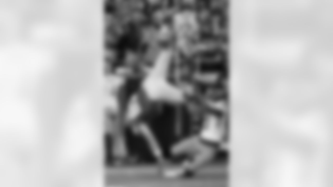 Kansas City Chiefs tight end Travis Kelce (87) is tackled after making a catch by Tennessee Titans cornerback Roger McCreary (21) during the first half of an NFL football game, Sunday, Nov. 6, 2022 in Kansas City, Mo. (AP Photo/Reed Hoffmann)