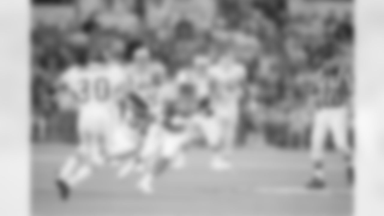 Houston Oilersâ€™ Gary Brown (33) is brought down after a seven-yard pass reception by Kansas City Chiefsâ€™ Derrick Thomas (58) in first quarter action at Houston, Jan. 6, 1994. (AP Photo/Rick Bowmer)