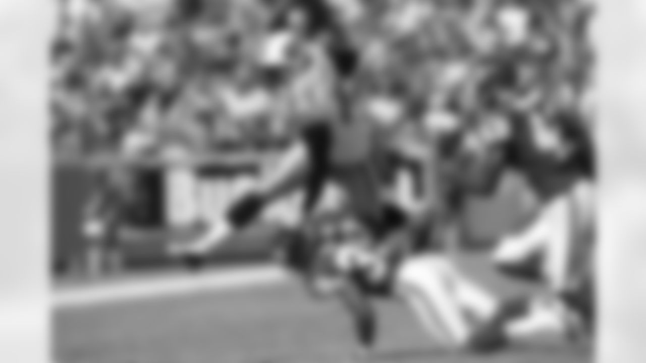 Alge Crumpler #83 of the Tennessee Titans hurdles over Brandon Carr #39 of the Kansas City Chiefs at Arrowhead Stadium on October 19 in Kansas City, Missouri.  Tennessee defeated Kansas City 34-10.  (AP Photo/G. Newman Lowrance)