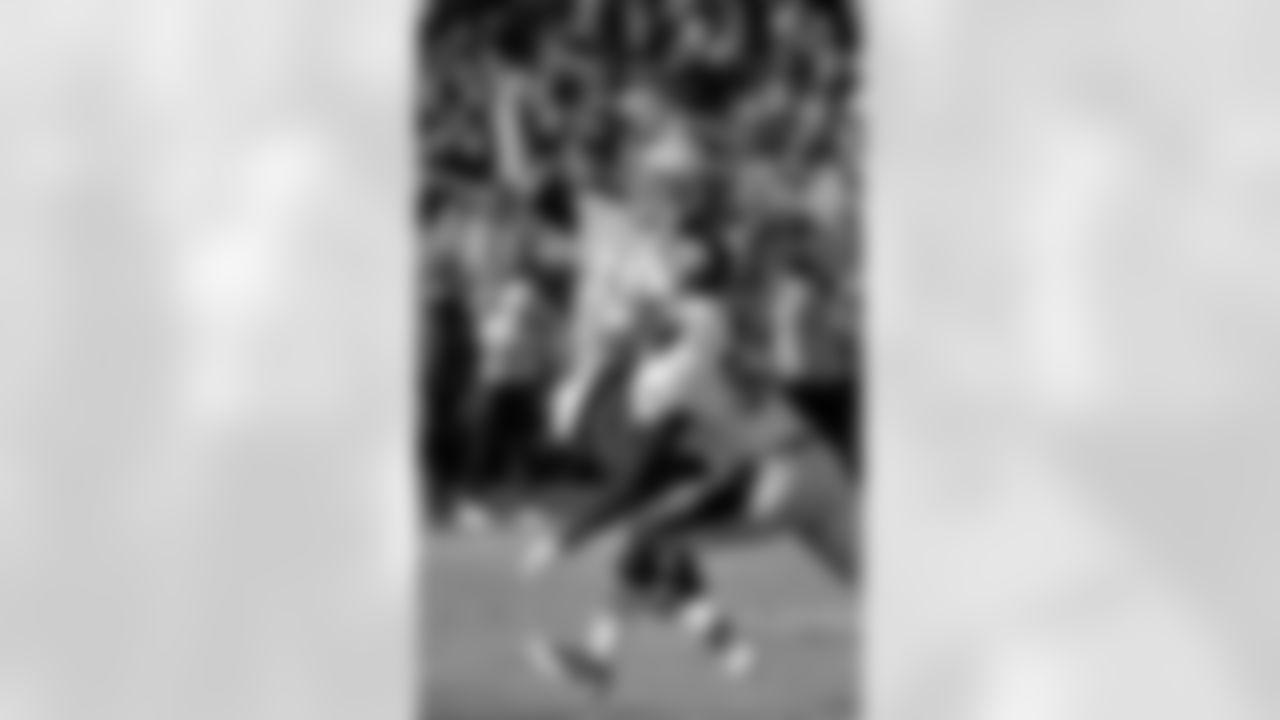 Tennessee Titans quarterback Jake Locker (10) passes as he is hit by New Orleans Saints defensive end Junior Galette (93) in the second quarter of an NFL football game on Sunday, Dec. 11, 2011, in Nashville, Tenn. (AP Photo/Frederick Breedon)