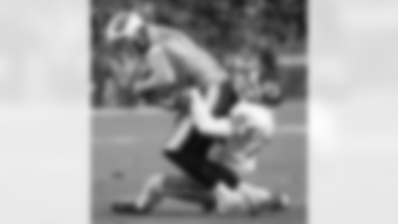 Tennessee Titans wide receiver  Drew Bennett, left, is brought down by Kansas City Chiefs cornerback William Bartee (24) in the first quarter on Monday, Dec. 13, 2004 in Nashville, Tenn. (AP Photo/Mark Humphrey)