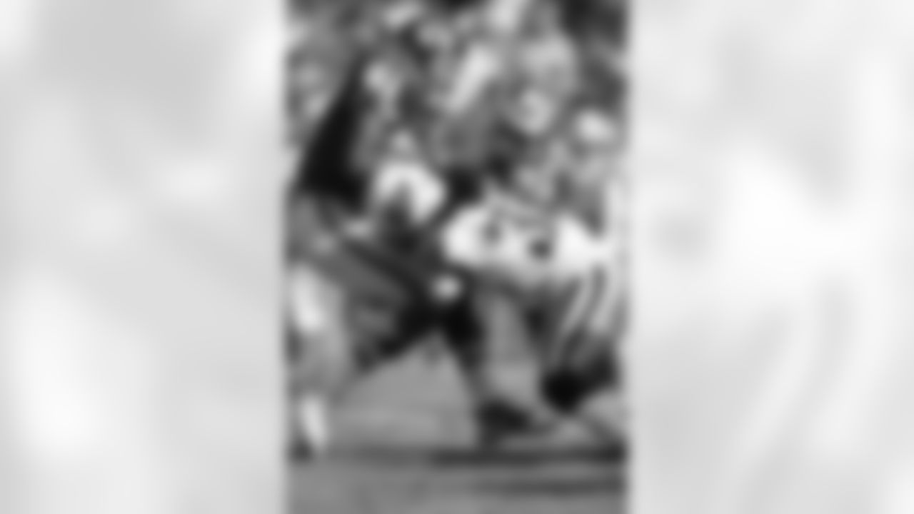 Michael Griffin #33 of the Tennessee Titans stops Kolby Smith #21 of the Kansas City Chiefs at Arrowhead Stadium on October 19 in Kansas City, Missouri.  Tennessee defeated Kansas City 34-10.  (AP Photo/G. Newman Lowrance)