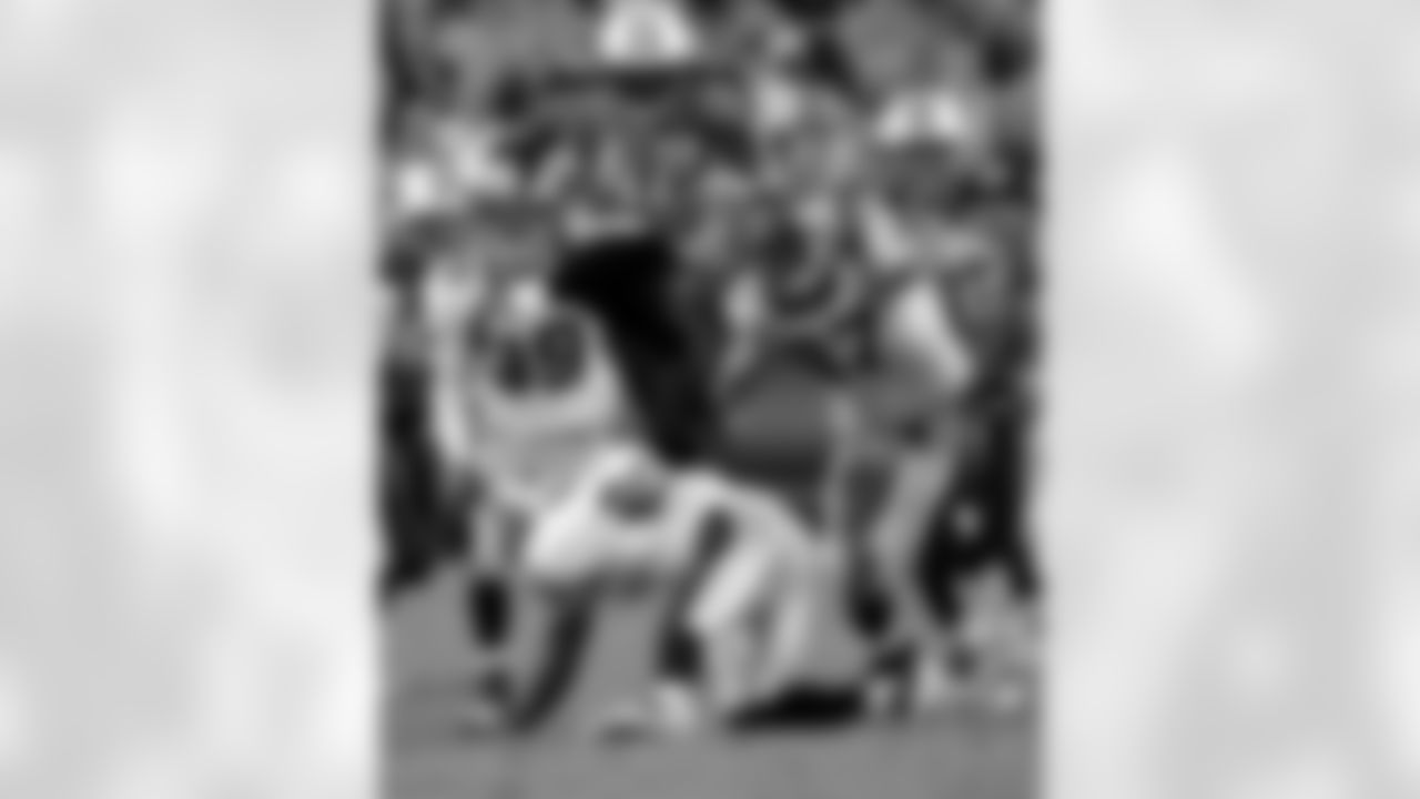 Tennessee Titans running back LeGarrette Blount (42) jumps over New Orleans Saints defender Chip Vaughn (21) during the second half their NFL preseason football game at LP Field in Nashville, Tenn., Thursday, Sept. 2, 2010. (AP Photo/Dave Martin)