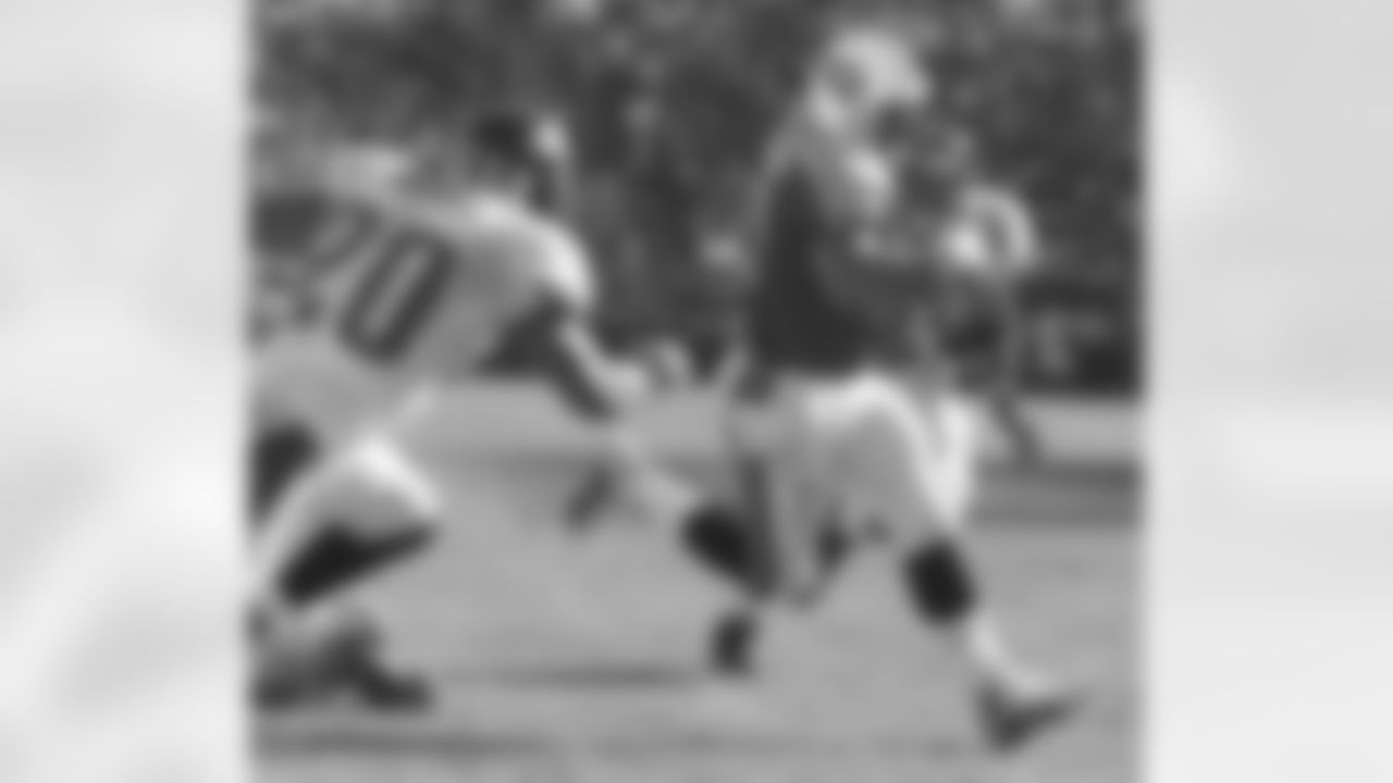 Tennessee Titans quarterback Steve McNair runs for a third-quarter touchdown as Jacksonville Jaguars strong safety Donovin Darius (20) and defensive end Tony Brackens (90) give chase during the Titan's 28-24 win Sunday, Nov. 4, 2001, in Nashville, Tenn. McNair had one of the better games of his career as he scrambled for 74 yards and was 27-of-34 for 241 yards passing. (AP Photo/Wade Payne)