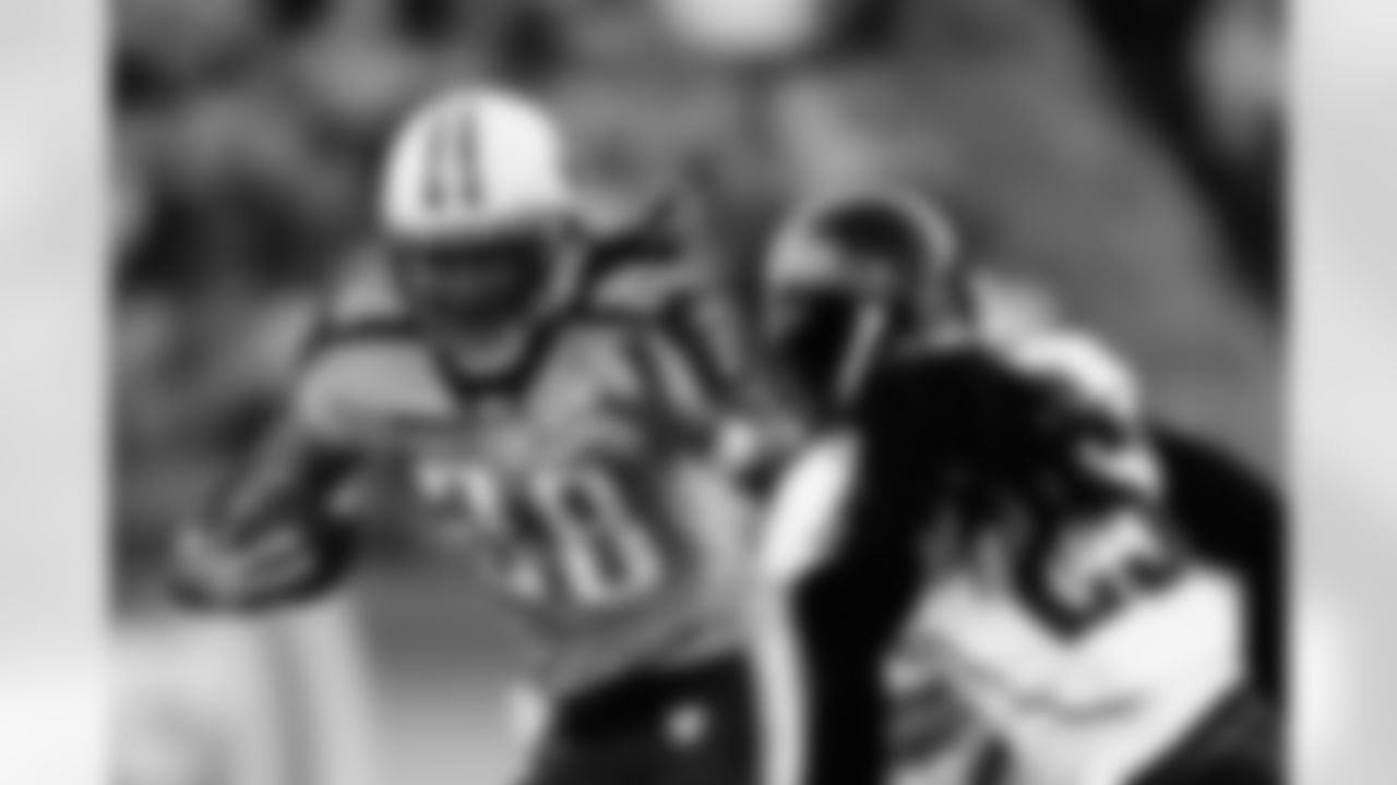 Runningback Chris Johnson (28) of the Tennessee Titans runs for yardage while being defended by safety Reggie Nelson (25) during an NFL game against the Jacksonville Jaguars  on Sunday November 1, 2009 in Nashville, TN.  The Titans  defeated the Jaguars  30-13.  (AP Photo/Jim Mahoney)