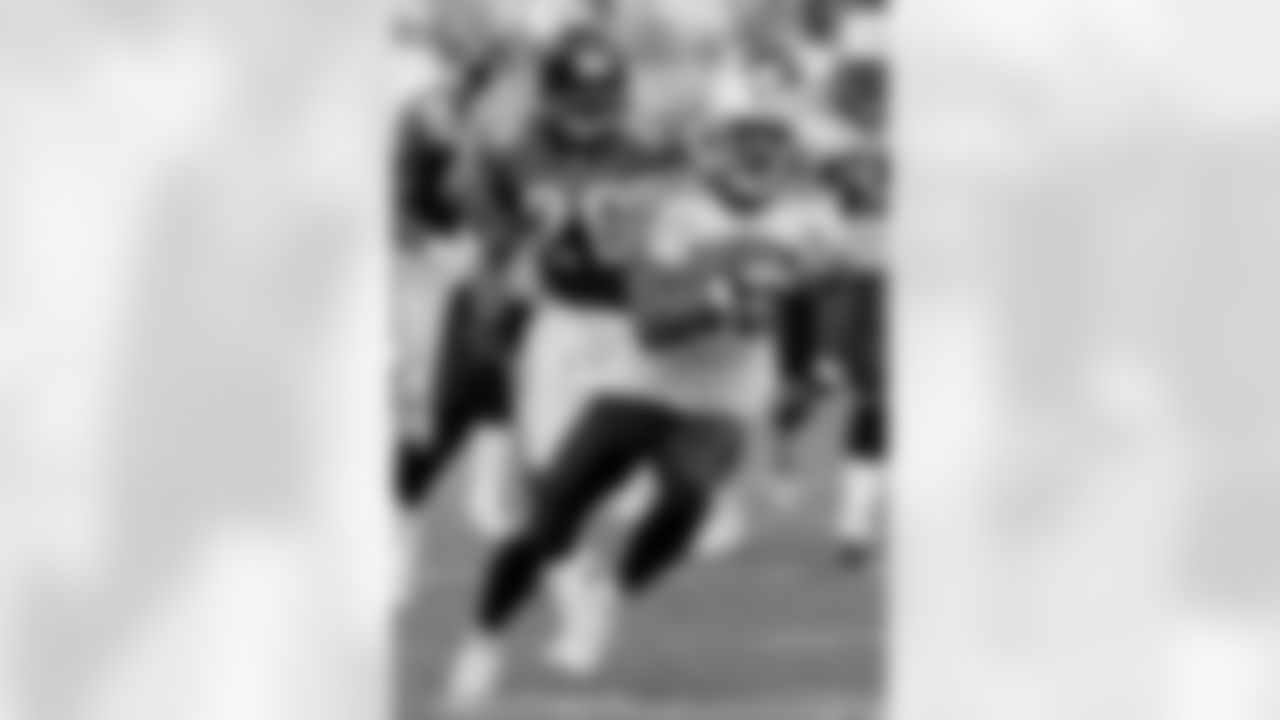 Tennessee Titans' Derrick Mason returns a punt 80 yards for a touchdown as Jacksonville Jaguars' Rayna Stewart gives chase during the third quarter of the Titans' 33-14 win in the AFC championship game Sunday, Jan. 23, 2000, in Jacksonville, Fla. The win advances the Titans to the Super Bowl next Sunday in Atlanta. (AP Photo/Peter Cosgrove)