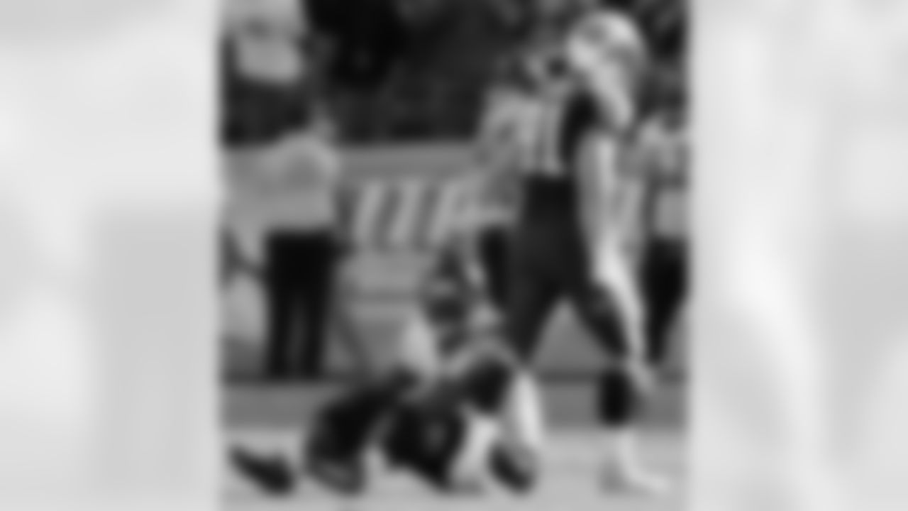 Tennessee Titans defensive end Travis LaBoy (91) pats Jacksonville Jaguars quarterback David Garrard (9) on the helmet after the Titans scored a touchdown on a pass interception in the third quarter of an NFL football game in Nashville, Tenn., Sunday, Dec. 17, 2006. Despite having only 41 yards total rushing and 57 yards total passing, the Titans defeated the Jaguars 24-17. (AP Photo/Mark Humphrey)