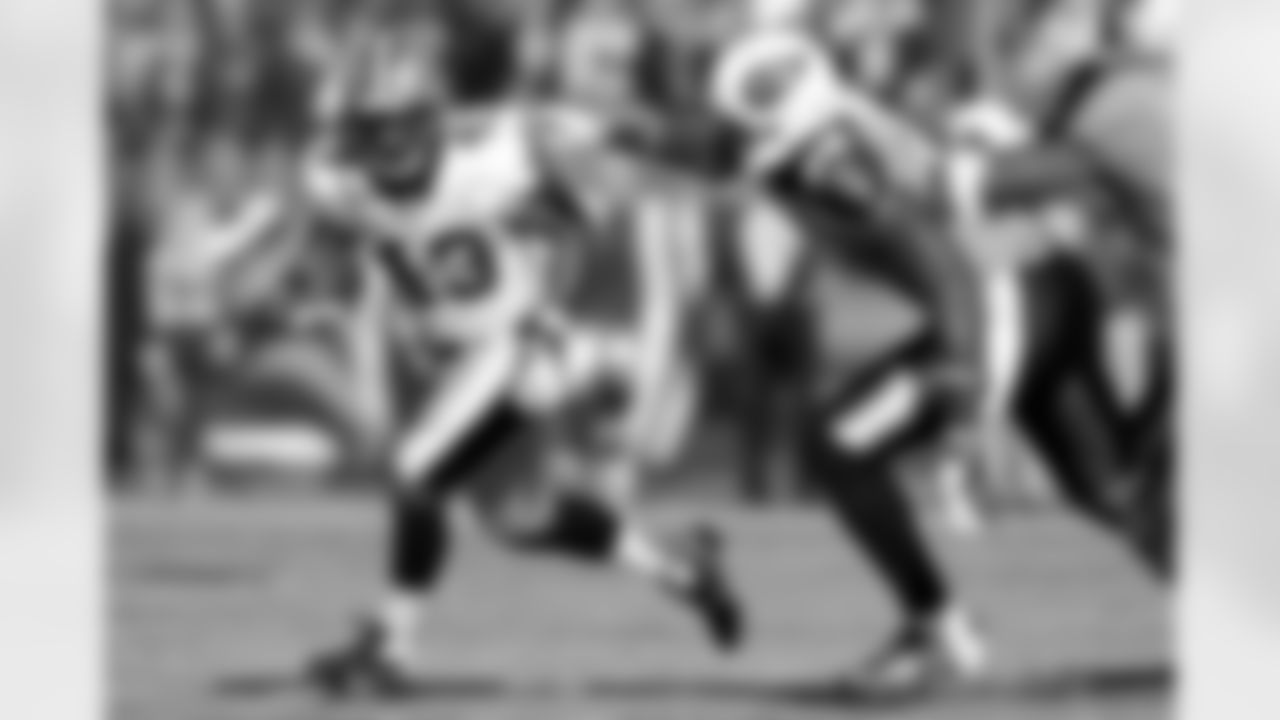 New Orleans Saints running back Darren Sproles (43) runs away from Tennessee Titans linebacker Akeem Ayers (56) in the first quarter of an NFL football game on Sunday, Dec. 11, 2011, in Nashville, Tenn. (AP Photo/Wade Payne)