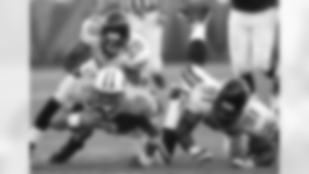 Tennessee Titans quarterback Steve McNair (9) is brought down by Jacksonville Jaguars cornerback Jason Craft (29) and defensive end Marco Coleman (91) after gaining 15 yards on a scramble in the third quarter on Sunday, Oct. 13, 2002 in Nashville, Tenn. McNair threw for 226 yards and one touchdown as the Titans defeated the Jaguars 23-14. (AP Photo/John Russell)